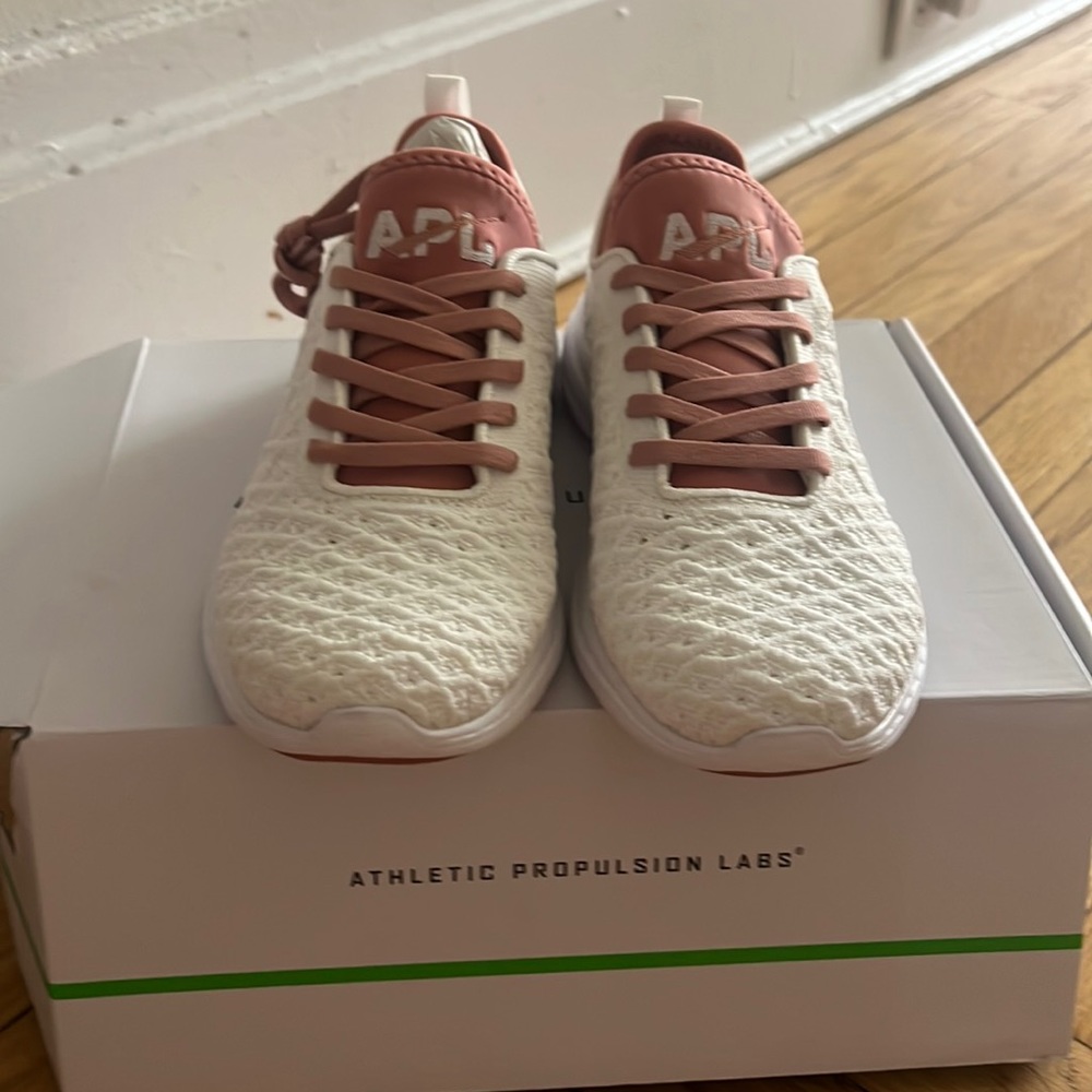 Brand new never worn white APL SNEAKERS with pink laces! Size 7